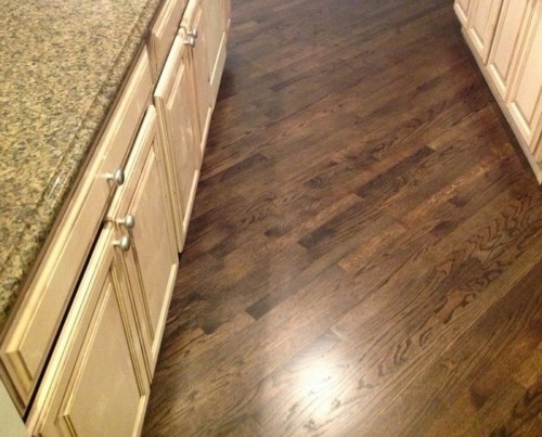 Dark stained hardwood floor in a kitchen