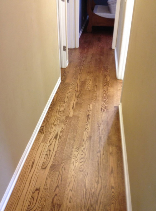 Wide plank hardwood flooring in a hallway