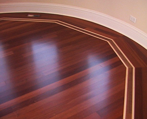 Inlays in hard hardwood flooring in curved room