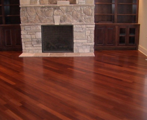 New hardwood floor surrounding a fireplace